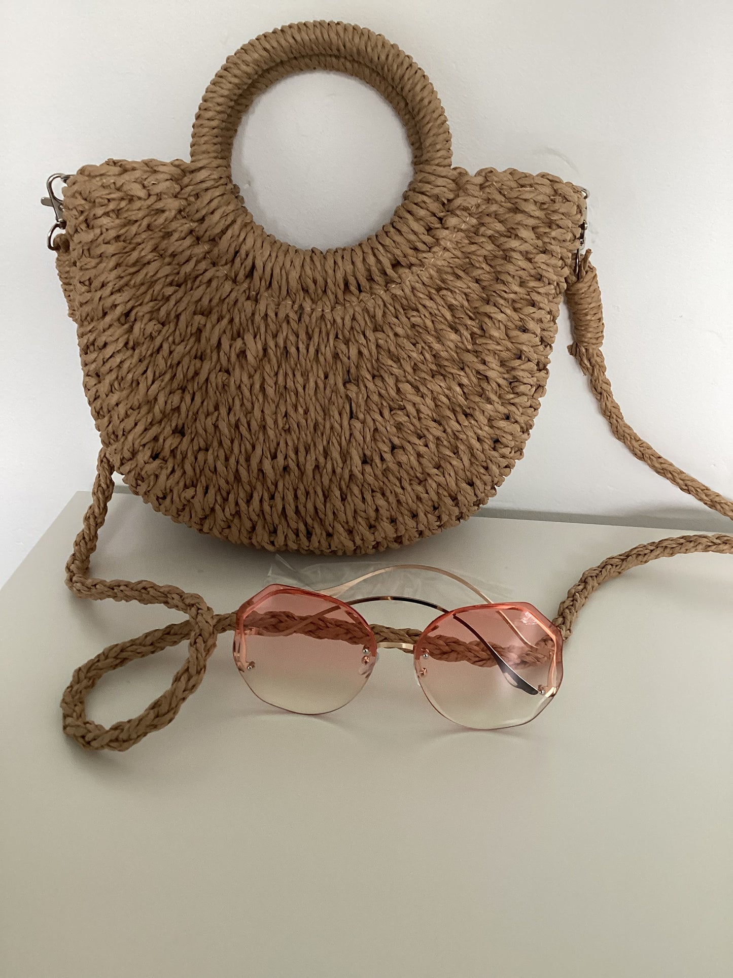 Handmade strawrattan half moon bag with handles and rose tint sunglasses