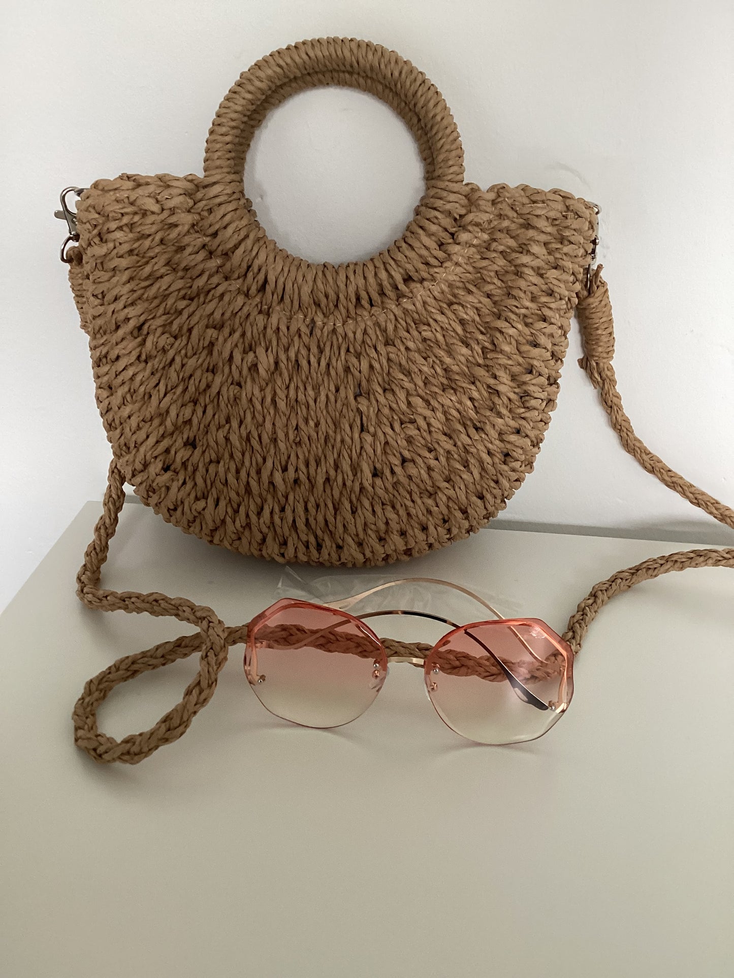 Handmade strawrattan half moon bag with handles and rose tint sunglasses